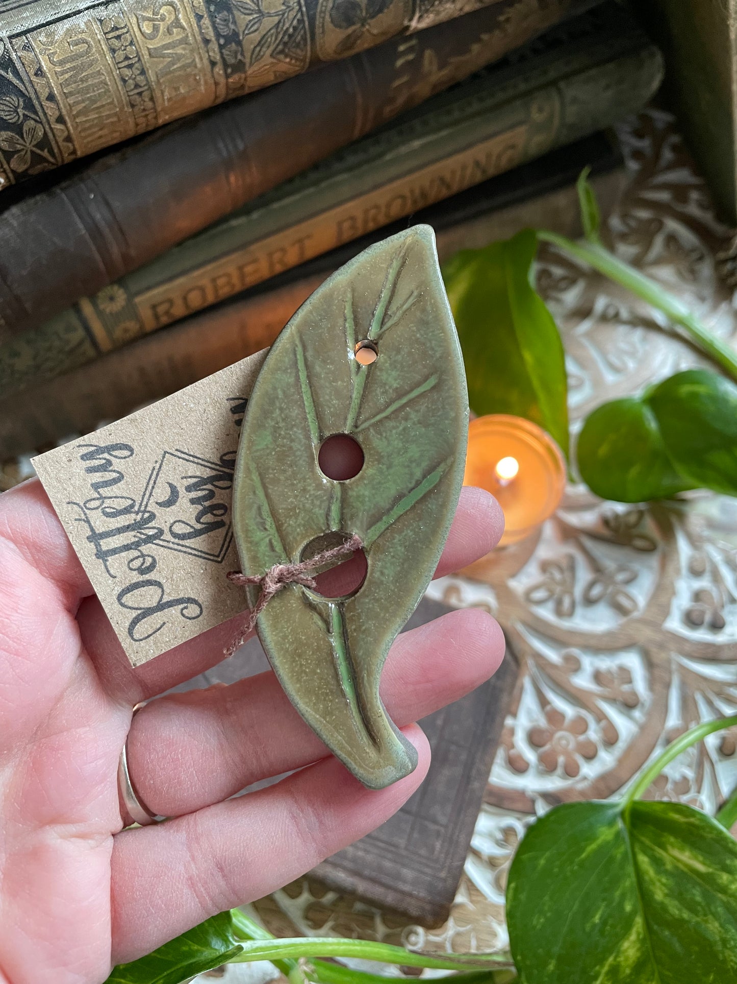 Rustic handmade ceramic herb stripper with natural green finish