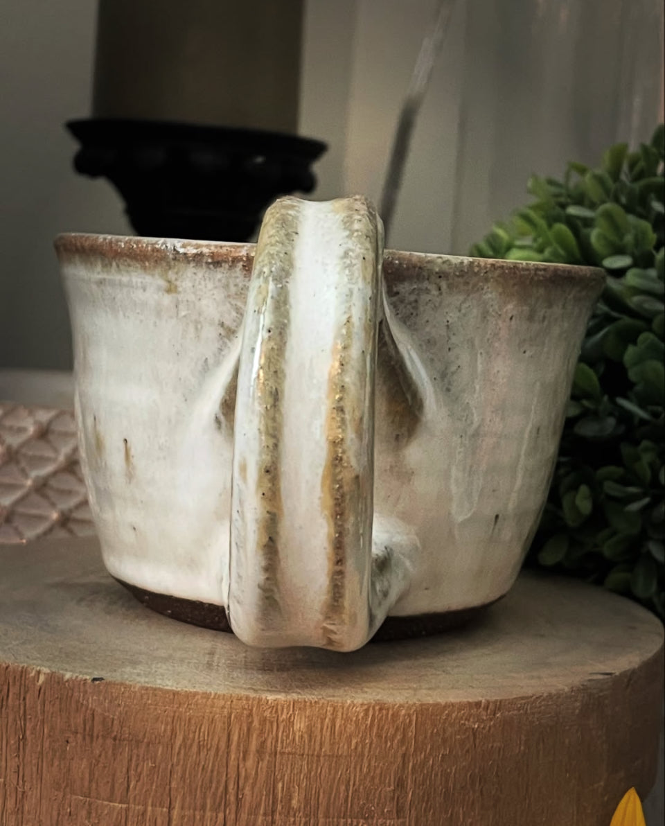 black clay ceramic mug with white glaze and swirl bottom