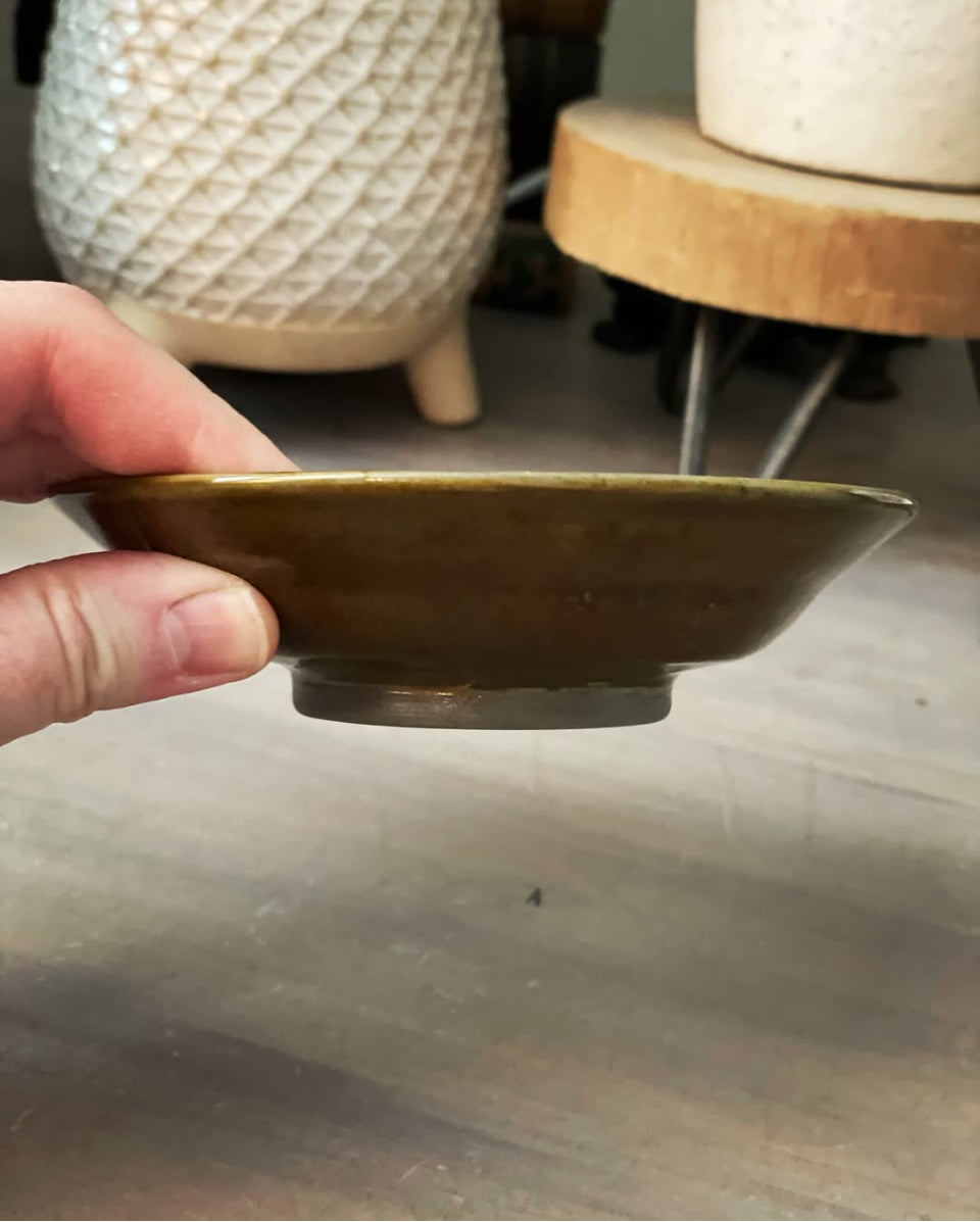 Handmade small brown bowl with swirl base