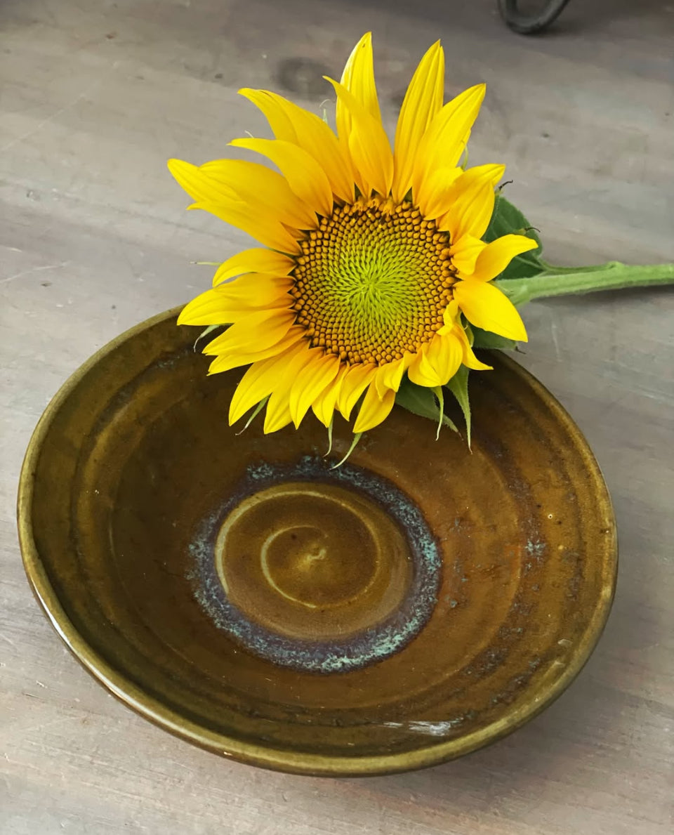 Handmade small brown bowl with swirl base