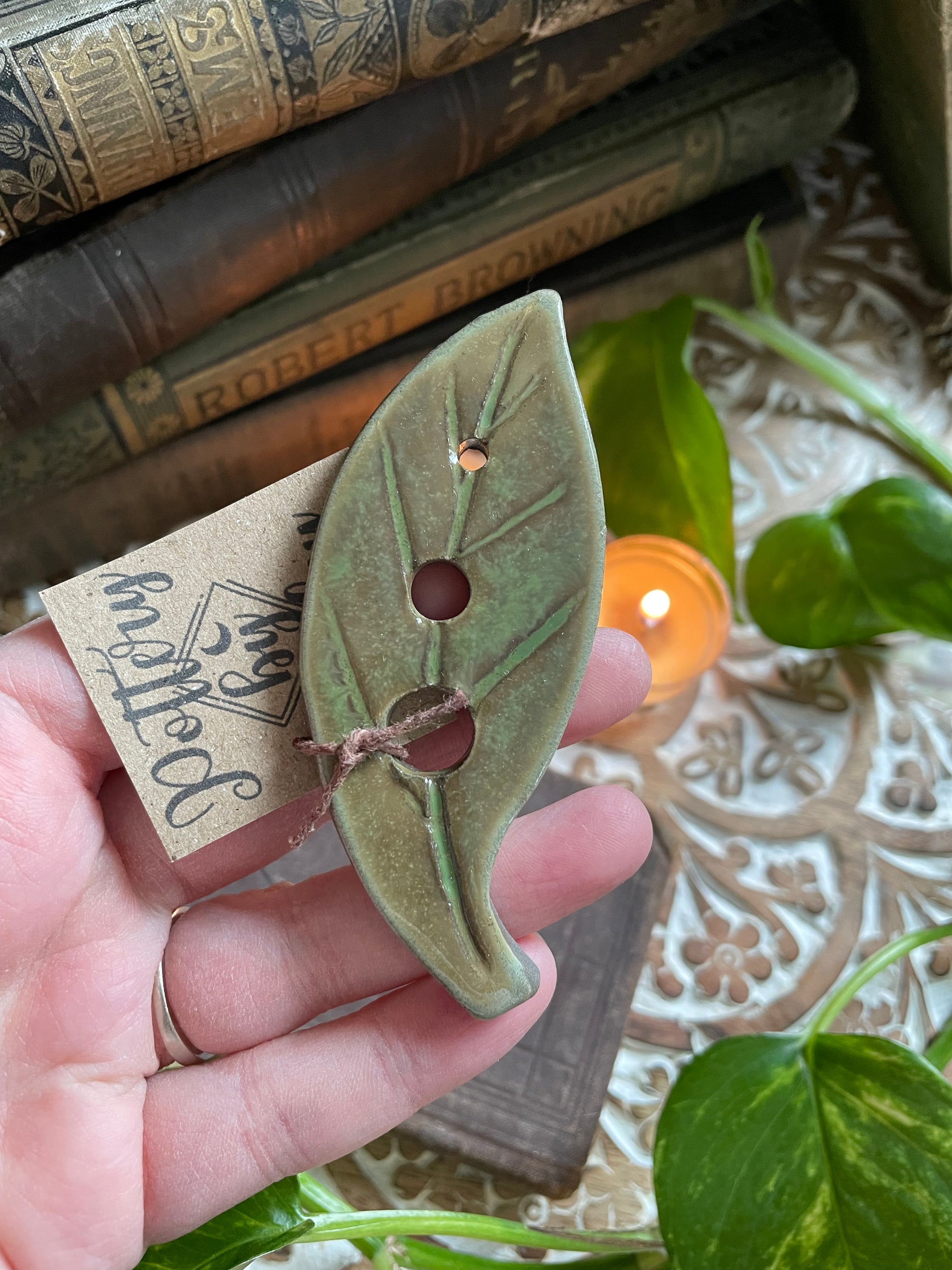 Rustic handmade ceramic herb stripper with natural green finish