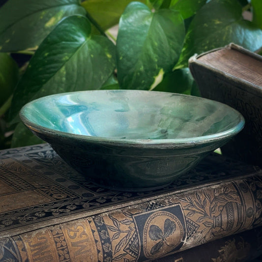 Handmade small green ceramic bowl with swirl bottom